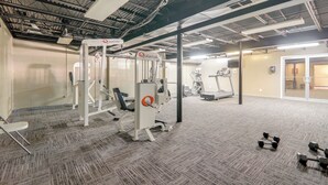 A gym with exercise equipment, a mirrored wall, and a door leading to another room. - 1 Mi to Dtwn & Uga: Condo w/ Pool in Athens! (Athens)