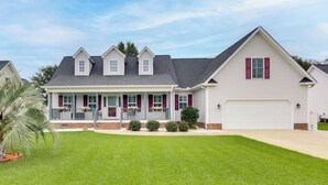 A two-story house with a front porch, a garage, and a well-maintained lawn. - Near Rev & Civil War History Museums! Camden Home (Camden)