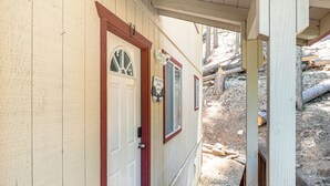 A wooden door with a window and a small sign above it. - Hike, Swim, Golf: Family Retreat in Arnold! (Arnold)