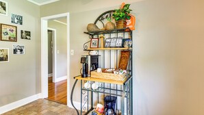 A home interior with a metal shelf unit displaying various items, a hallway with wooden flooring, and a door leading to another room. - 8 Mi to Clemson: Peaceful Family Home w/ Yard (Seneca)