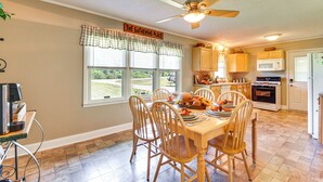 A dining area with a wooden table, chairs, and a ceiling fan. - 8 Mi to Clemson: Peaceful Family Home w/ Yard (Seneca)