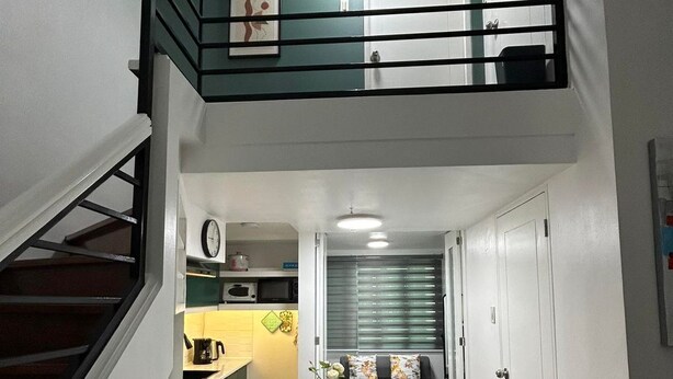 A modern apartment with a kitchen, dining area, and a loft bedroom. - Simple but Cozy, Feel at Home (Mandaluyong)