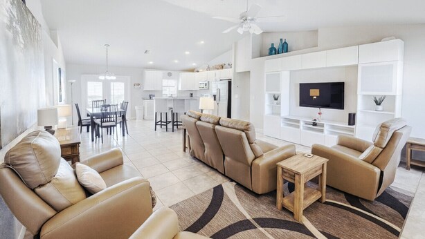 A modern living room with a sofa set, a coffee table, and a TV.