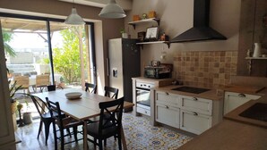Une cuisine équipée d’un coin repas, d’un four à micro-ondes, d’une cuisinière et d’un évier.