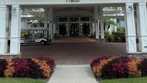 A covered entrance with a number sign, a golf cart, and a pathway leading to the doors. - Best Amenities Resort- Bonita Spring, FL- 2BD/2BA (Bonita Springs)