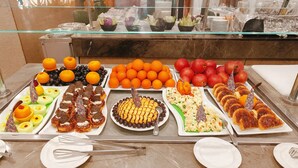 A buffet with various food items including fruits, pastries, and a cake. - Nile Cruise Suites Only every Friday from Aswan 3 nights & every Monday from Luxor 4 nights (Aswan)