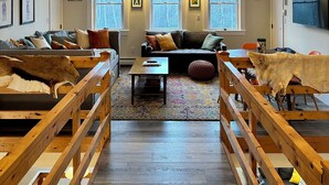 A spacious loft with high ceilings, exposed wooden beams, and large windows offering views of the outdoors. - Three Peaks Hideaway, a Tranquil 4-bedroom house with Mountain Views in Peru (Peru)