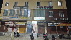 A multi-story building with various businesses including a library, a restaurant, and a hotel. - The haveli lounge and restaurant (Udaipur)