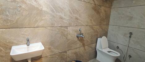 A bathroom with a sink, toilet, and shower.