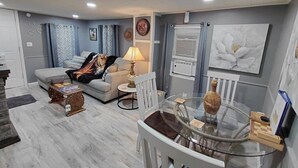 A living room with a sofa, a glass coffee table, and a lamp. - “Rancho” by the Lake 1 block from Lake Erie (Dunkirk)