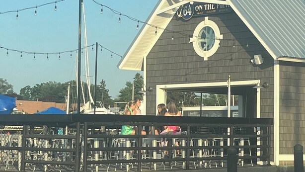 A building with a sign reading "ON THE PILGRIMAGE" and a dock area with boats. - “Rancho” by the Lake 1 block from Lake Erie (Dunkirk)