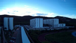 A high-rise building complex with multiple floors and a parking area in front. - Rest apartment in Girardot. (Girardot)