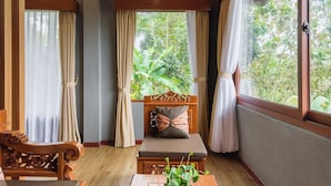 A room with a wooden bench, a cushioned seat, and a window with curtains. - Calma Coliving at Jatiluwih, Bali (Penebel)