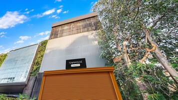A modern building with a sign indicating it is a company-serviced townhouse.