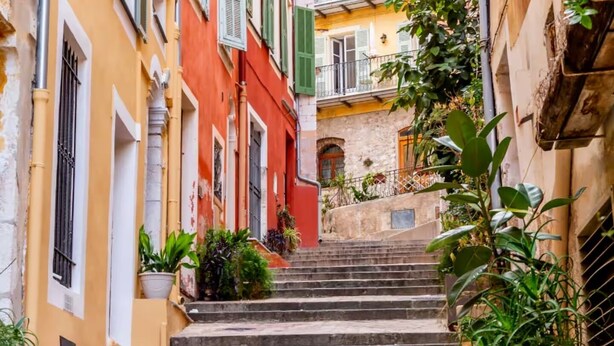 A narrow street with a set of stone steps leading up to a building with a balcony. - Mediterranean Horizon (Villefranche-sur-Mer)
