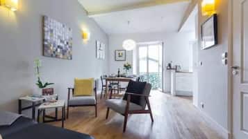 Design Apartment, Balcony, City View | Living area | 55-inch flat-screen TV with digital channels