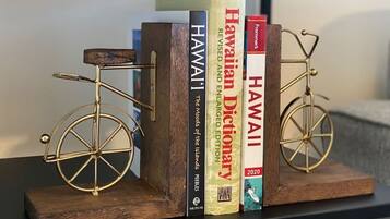 A bookshelf with books and two decorative bicycles.