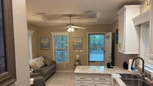 A kitchen with white cabinets, a granite countertop, and a built-in sink.