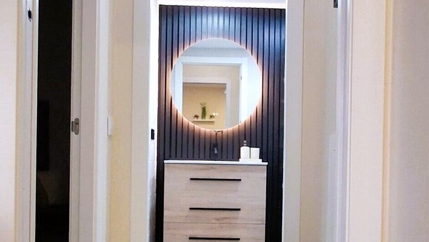 A hallway with a vanity, wooden flooring, and a door leading to another room. - Loft Flor de Azahar with FREE PRIVATE PARKING (Córdoba)