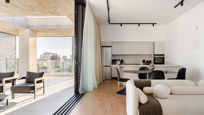 A modern apartment with a balcony, a dining area, and a kitchenette. - Yamas Urban Living Sequoia Residence (Limassol)