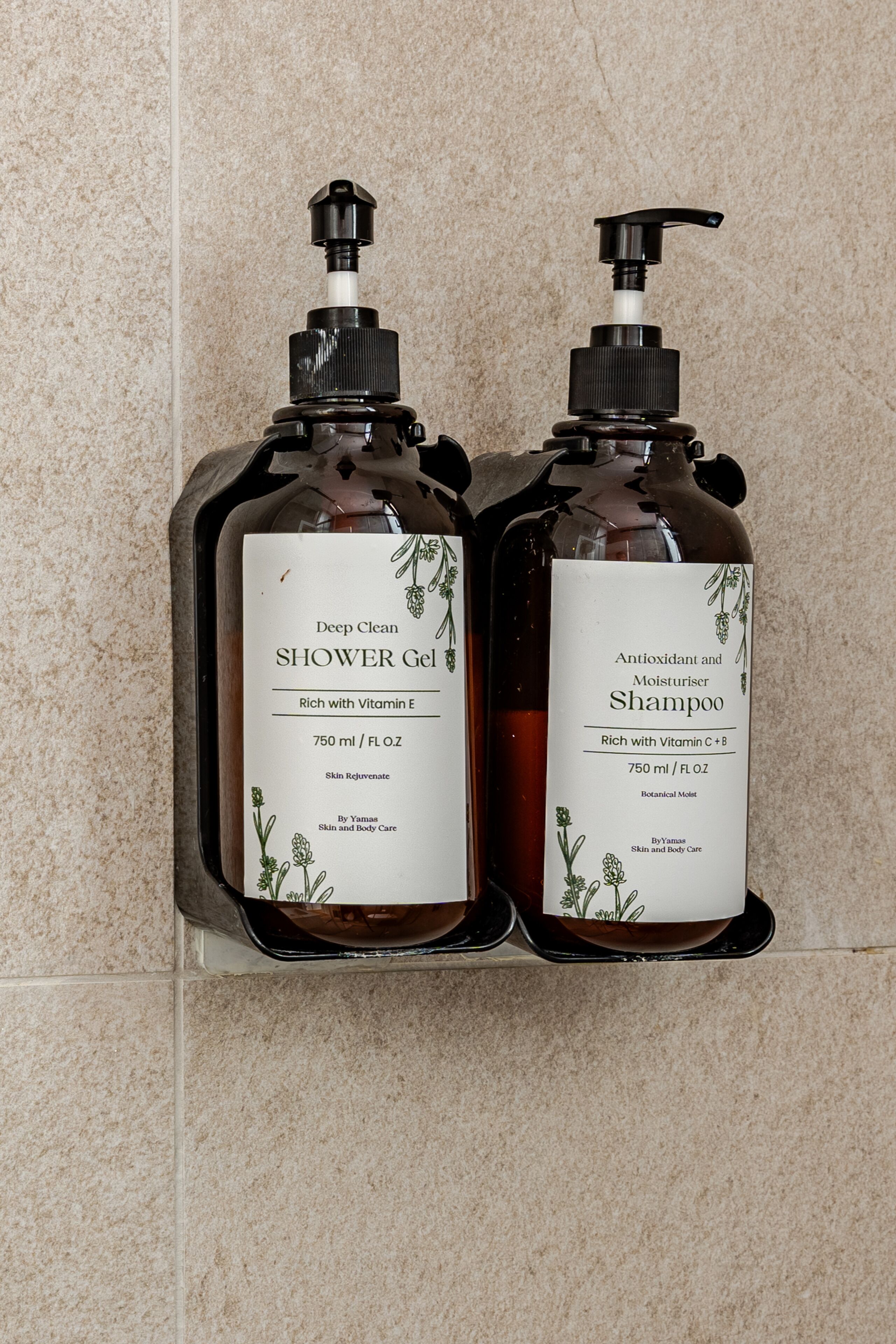 Two bottles of shower gel and shampoo on a tiled wall.