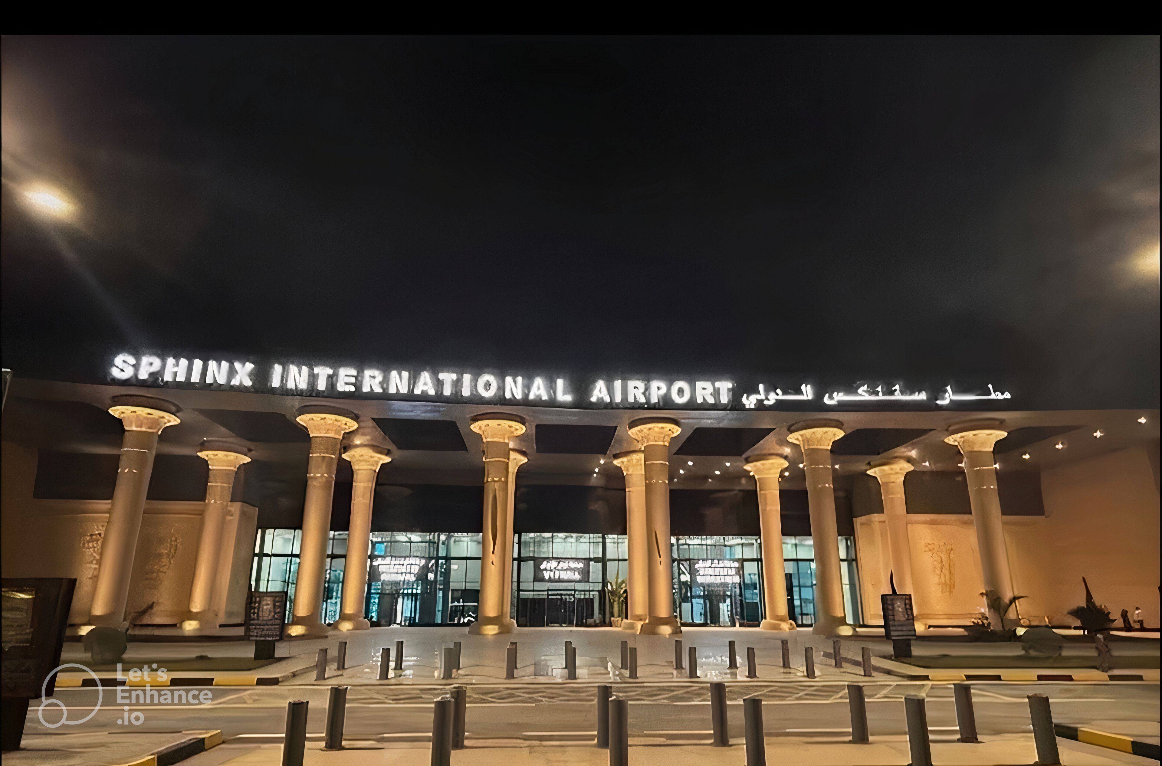 The entrance to Sphinx International Airport with illuminated signage and classical columns.