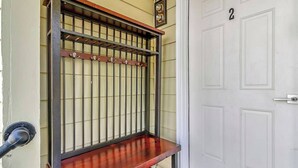 A metal gate with a wooden bench in front of a white door with the number 2. - Cozy Rutland Retreat (Rutland)