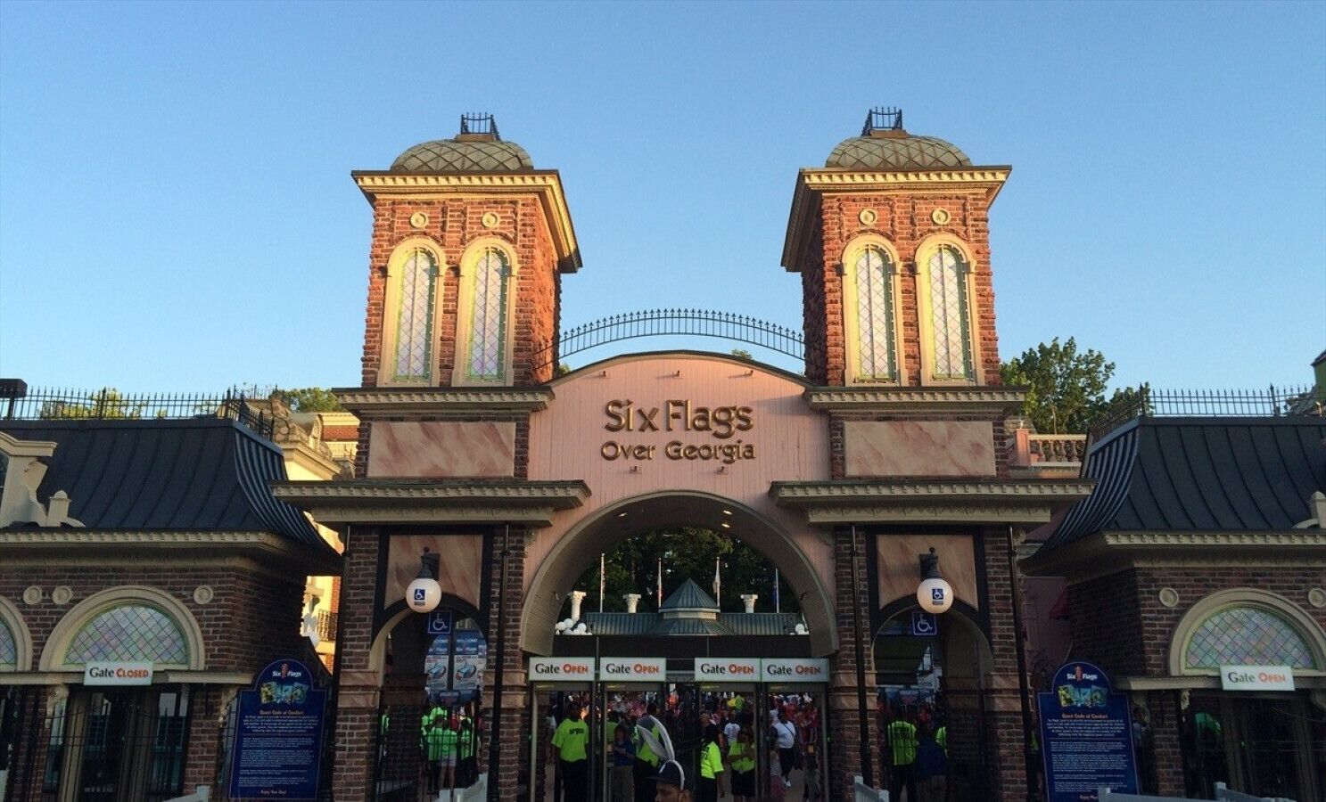 A historic building entrance with a sign reading 'Six Flags Over Georgia' and multiple gates.
