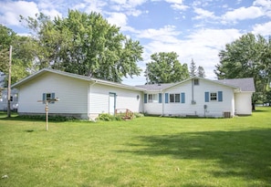 A two-story mobile home with a front porch and a small attached garage.