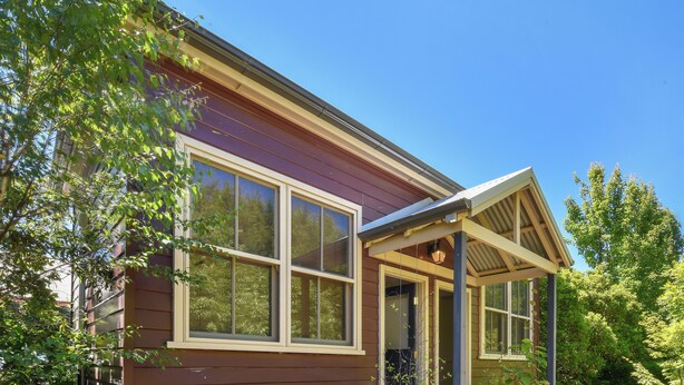 A studio accommodation with a wooden exterior, large windows, and a covered porch. - Coolangatta (House and Studio) (Katoomba)