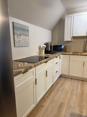Fridge, microwave, stovetop, coffee/tea maker