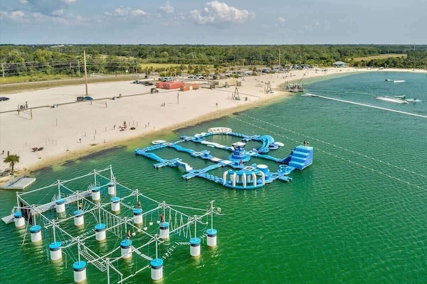 Local Favorite, SunWest Park (12 min): White sandy beach on a spring-fed lake with swimming, paddleboarding, and the inflatable floating aqua park—fun for both kids and adults.