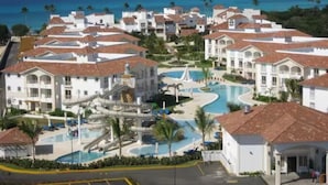 A resort with multiple buildings, a central pool area, and a water slide. - Studio with beach and pool access at Club Cadaqués, Bayahibe (San Rafael de Yuma)