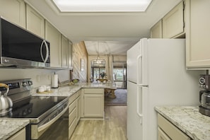A modern kitchen with stainless steel appliances, a wooden island, and a view to the backyard. - Last-Min Summer Escape! 15% Off Your August Stay. Must Book By 8/17/26. (Pagosa Springs)