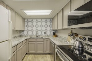 A kitchen with light-colored cabinets, a stainless steel kettle, a marble countertop, and patterned backsplash tiles. - Last-Min Summer Escape! 15% Off Your August Stay. Must Book By 8/17/26. (Pagosa Springs)