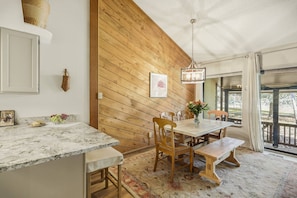 A dining area with a wooden wall, a marble countertop, and a bench. - Last-Min Summer Escape! 15% Off Your August Stay. Must Book By 8/17/26. (Pagosa Springs)