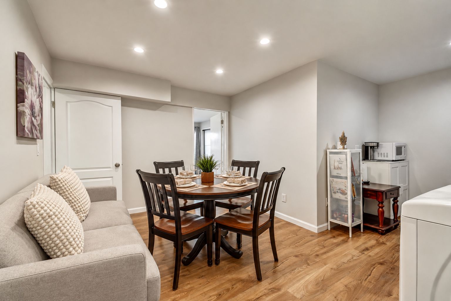 A compact living space with a dining area, a kitchenette, and a seating area.