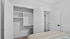 A bedroom with a bed, a wardrobe, and a door leading to a bathroom. - Spacious 2 bedroom unit in North Edmonton. (Edmonton)