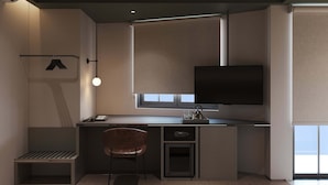 Una cocina moderna con televisor integrado, un banco y un refrigerador pequeño.