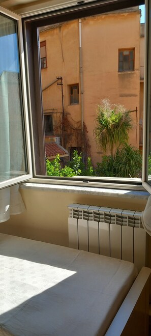 A room with a window overlooking a building and some greenery. -  Stay in the Heart of Agrigento, on Via Atenea, near the Valley of the Temples (Agrigento)