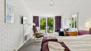 A hotel room with a bed, a desk, a chair, and a view of the outdoors. - "Bengta" - 250m from the sea by Interhome (Nexø)