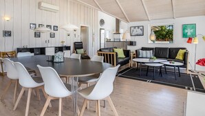 A spacious living area with a dining table, chairs, sofas, and a kitchen in the background. - "Rosamunde" - 700m from the sea by Interhome (Sydals)