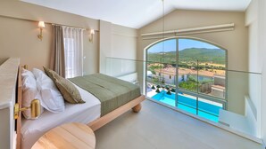 Une chambre avec un lit, une vue sur une piscine et un balcon doté d’une balustrade en verre.