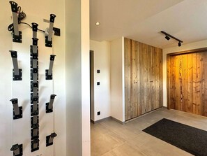 A modern interior with a wooden panel wall and a door.
