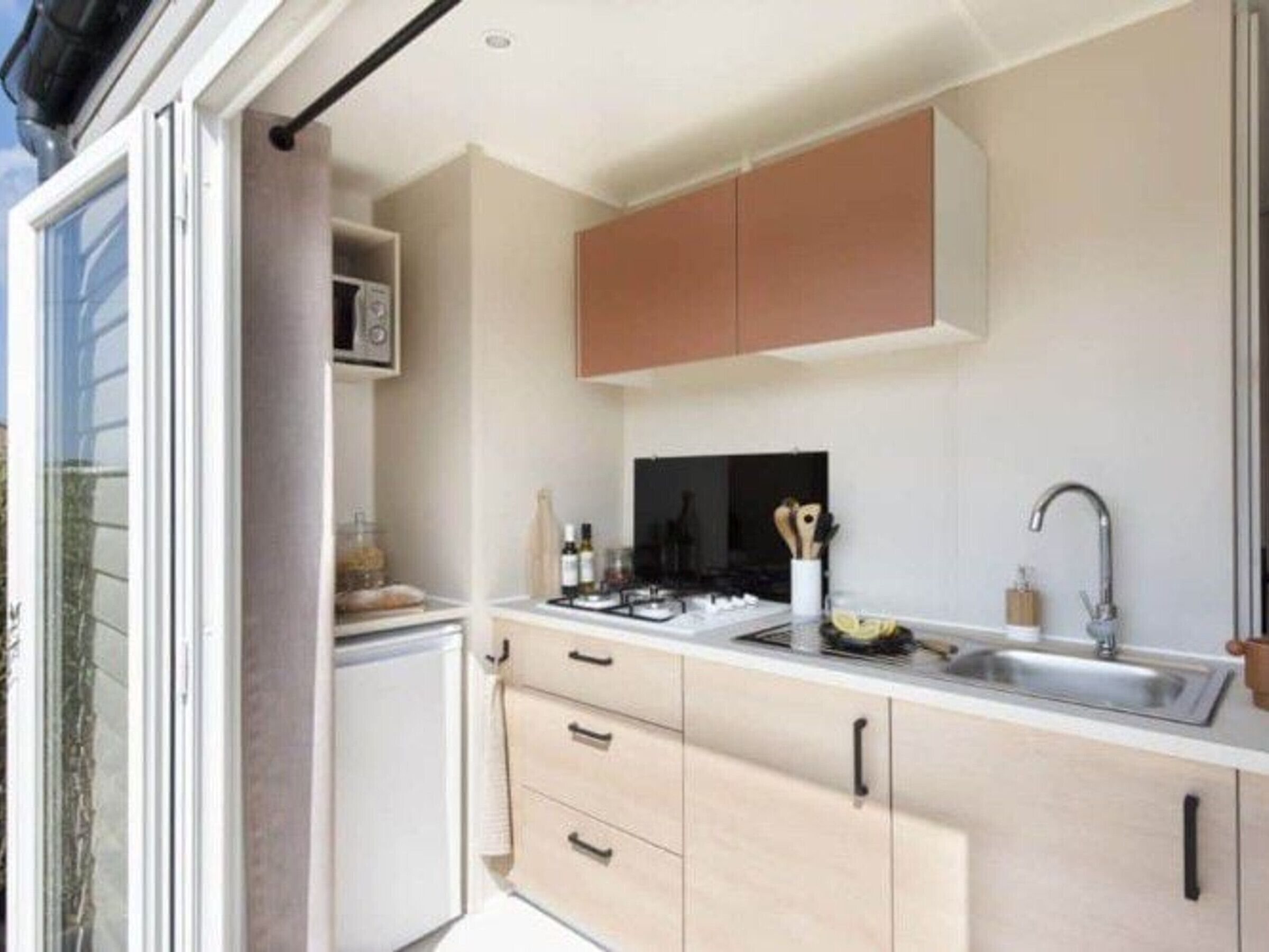 A modern kitchen with a microwave, stove, and sink.