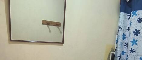 A bathroom with a sink, toilet, and a mirror.