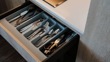 A drawer with neatly organized cutlery including forks, knives, and spoons.