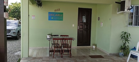 A building entrance with a sign reading "DECARLI" and a contact number.