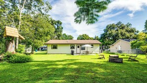 A single-story house with a front porch, a small deck, and a well-maintained lawn. - Explore Weeki Wachee Springs: Pet-friendly Home (Brooksville)