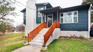 A two-story house with a front porch and a staircase. - Porch & Yard, Spacious & Cozy, Close to Downtown! (Raleigh)